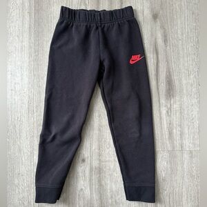 Black sweatpants with red Nike logo
